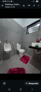 a bathroom with a white toilet and a sink at Recanto Rafaela 2 in Olímpia +25 photos
