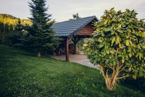 a house with a tree in front of it at Zacisze Krzeszów in Krzeszów