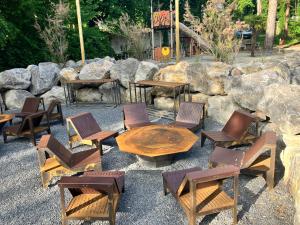 a group of chairs and a wooden table and chairs at Camping La Dune Blanche - Daly's home in Camiers +7 photos