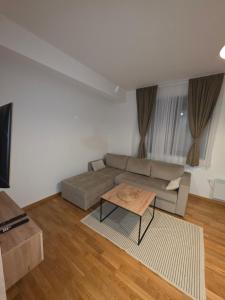 a living room with a couch and a coffee table at Vila#Borova#800m in Zlatibor