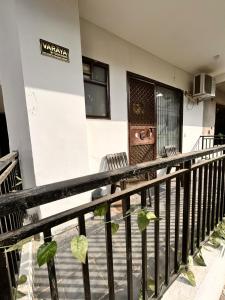 a balcony of a building with a sign on it at Varāya 1RK Studio in Vrindāvan +16 photos