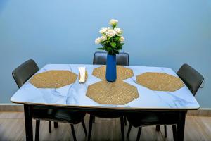 a table with a vase of flowers on top of it at Travellers Palace Hotel in Kampala
