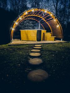a tunnel with stepping stones in a park at night at Zacisze Krzeszów in Krzeszów