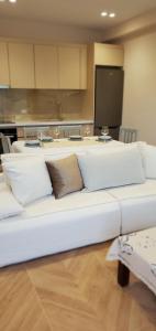 a white couch with pillows in a room at Villa Shelegar in (( Metoq ))
