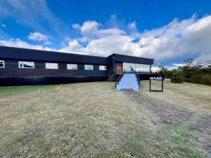 a large building with a staircase in front of it at Geikie Lodge in Torres del Paine