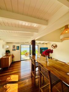 a dining room with a wooden table and chairs at Case Macalpa in Saint Barthelemy +12 photos