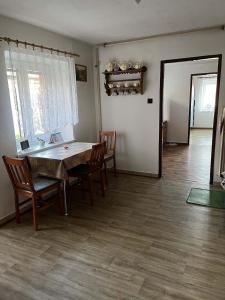 a dining room with a wooden table and chairs at chalupa na Vysočině in Věž +10 photos