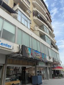 a building with a sign on the side of it at Paris and Eneas Studios in Vlorë
