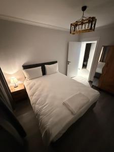 a bedroom with a large white bed and a chandelier at Twelve Diamond Hotel in Istanbul