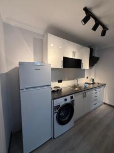 a kitchen with a refrigerator and a washing machine at Twelve Diamond Hotel in Istanbul