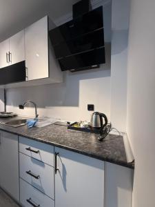 a kitchen with white cabinets and a tea kettle on the counter at Twelve Diamond Hotel in Istanbul +1 photo