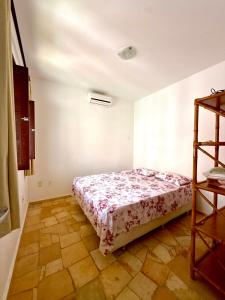 a bedroom with a bed in a room at Triplex em Maracajaú a beira-mar in Maxaranguape +20 photos