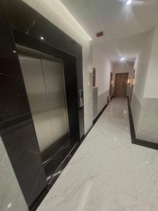 an empty hallway of a building with a elevator at Enea Apartments 8 in Tirana
