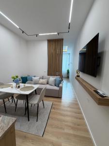 a living room with a couch and a table at Paris and Eneas Studios in Vlorë