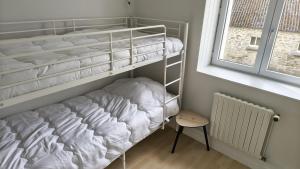 a bedroom with a bunk bed and a window at Gîte de la Verdière Spa Pool Valley in Le Sourn +62 photos