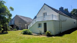 a large white house with a large yard at Gîte de la Verdière Spa Pool Valley in Le Sourn