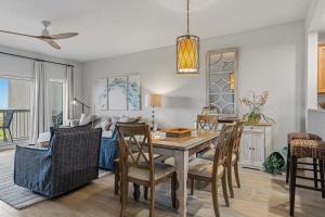 a dining room and living room with a table and chairs at Easy Beach Walk Pools and Hot Tubs in Destin