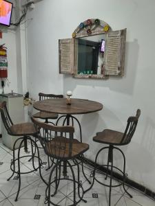 a table and chairs in a room with a mirror at Hotel Silveira in Guarapari +27 photos
