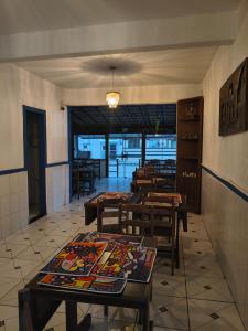 a restaurant with tables and chairs in a room at Hotel Silveira in Guarapari