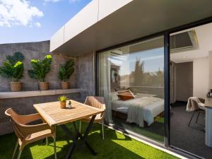a bedroom with a bed and a table and chairs at İS Hotel in Antalya +2 photos