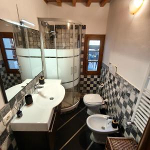 a bathroom with a sink and a shower and a toilet at Tuscan Sunsets Tramonti Toscani in Fauglia +20 photos