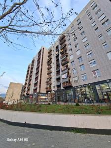 a large apartment building with a garden in front of it at Enea Apartments 8 in Tirana +6 photos