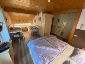 a room with a bed and a table and chairs at Garni al Barance in Selva di Cadore