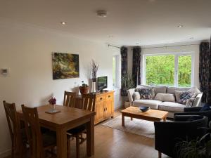 a living room with a couch and a table at Glanafon in Abergorlech