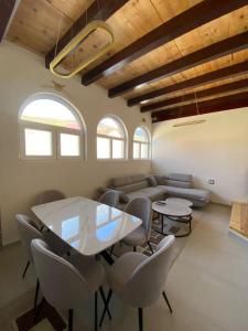 a living room with a table and chairs and a couch at Blue Nest in Plav