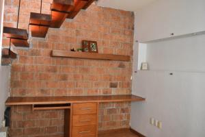 a brick wall in a kitchen with a brick fireplace at Valentin House, very spacious and cozy. in San Luis Potosí +34 photos