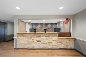 an empty lobby with an american flag at Suburban Studios Near Camp Lejeune in Jacksonville +66 photos