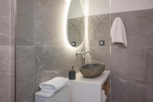 a bathroom with a sink and a mirror at Limonletto in Patmos +21 photos