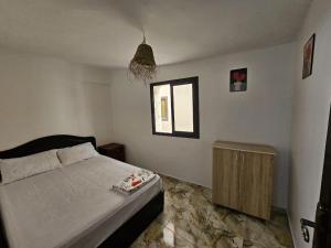 a bedroom with a bed and a window at ADAGHAS studio 1,3 in Agadir
