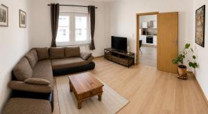 a living room with a couch and a table at Ferienwohnung Ernzerhof in Idar-Oberstein