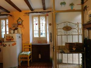 a kitchen with a refrigerator and a window at Gioco dell'oca in Ponna Superiore