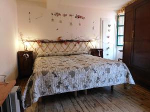 a bedroom with a bed with a comforter at Gioco dell'oca in Ponna Superiore