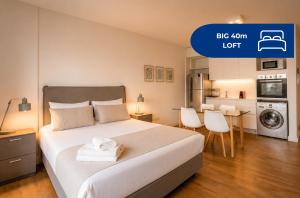 a bedroom with a large bed and a kitchen at Live Belgrano Boutique Apartments in Buenos Aires