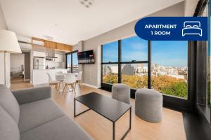 a living room with a couch and a table at Live Belgrano Boutique Apartments in Buenos Aires