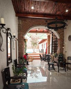 a lobby with chairs and a person sitting in a room at Casalajud Wellness in Taganga