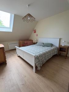 a bedroom with a large bed in a room at La Parenthèse in Le Plouy