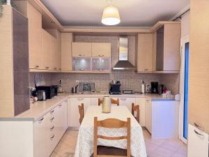 a kitchen with a table and chairs in it at Krithia Apartment with Garden Family Apartment in Krithiá