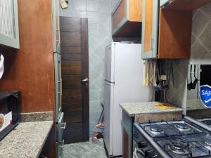 a small kitchen with a refrigerator and a stove at Modern 3-BR gated Sheikh Zayed Compound Open Views in Sheikh Zayed
