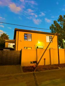 a house with a light on the side of it at Be my guest in Roodepoort