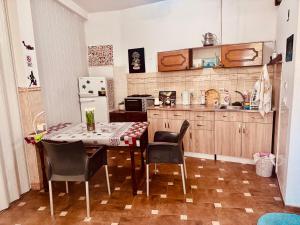 a kitchen with a table and chairs and a refrigerator at Private Room & Terrace in Skopje