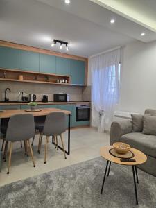 a kitchen and living room with a couch and a table at Sunset Apartment in Kotor