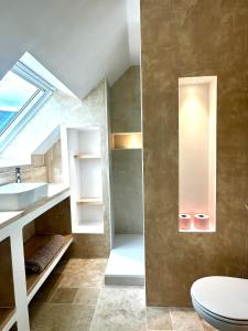 a bathroom with a sink and a toilet at Bel appartement sous combles in Argelès-Gazost +47 photos