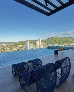 a deck with chairs and a view of the water at Flat mobiliado no CITY HOUSE in Barreiras