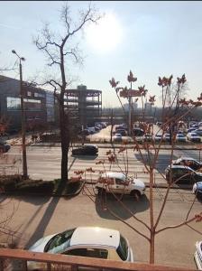 a parking lot with cars parked in a parking lot at Central Apartman Tatabánya in Tatabánya