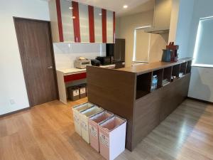 a kitchen with a counter with boxes in it at House Villa Koharu in Asahikawa