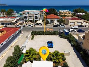 a view of a city with a street and a beach at Luxury Villa Eva-Mari with jacuzzi, 50m from the beach in Stalos